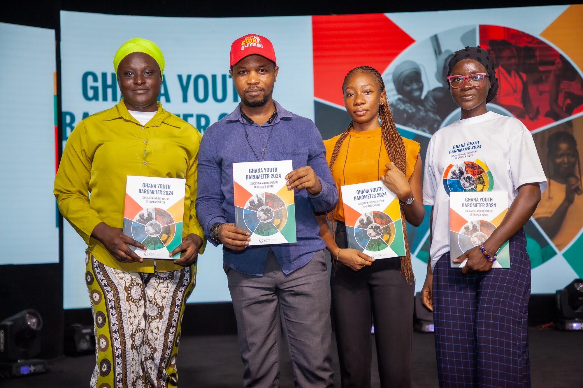 A group picture of 4 youth attendees holding up the Ghana Youth Barometer Report